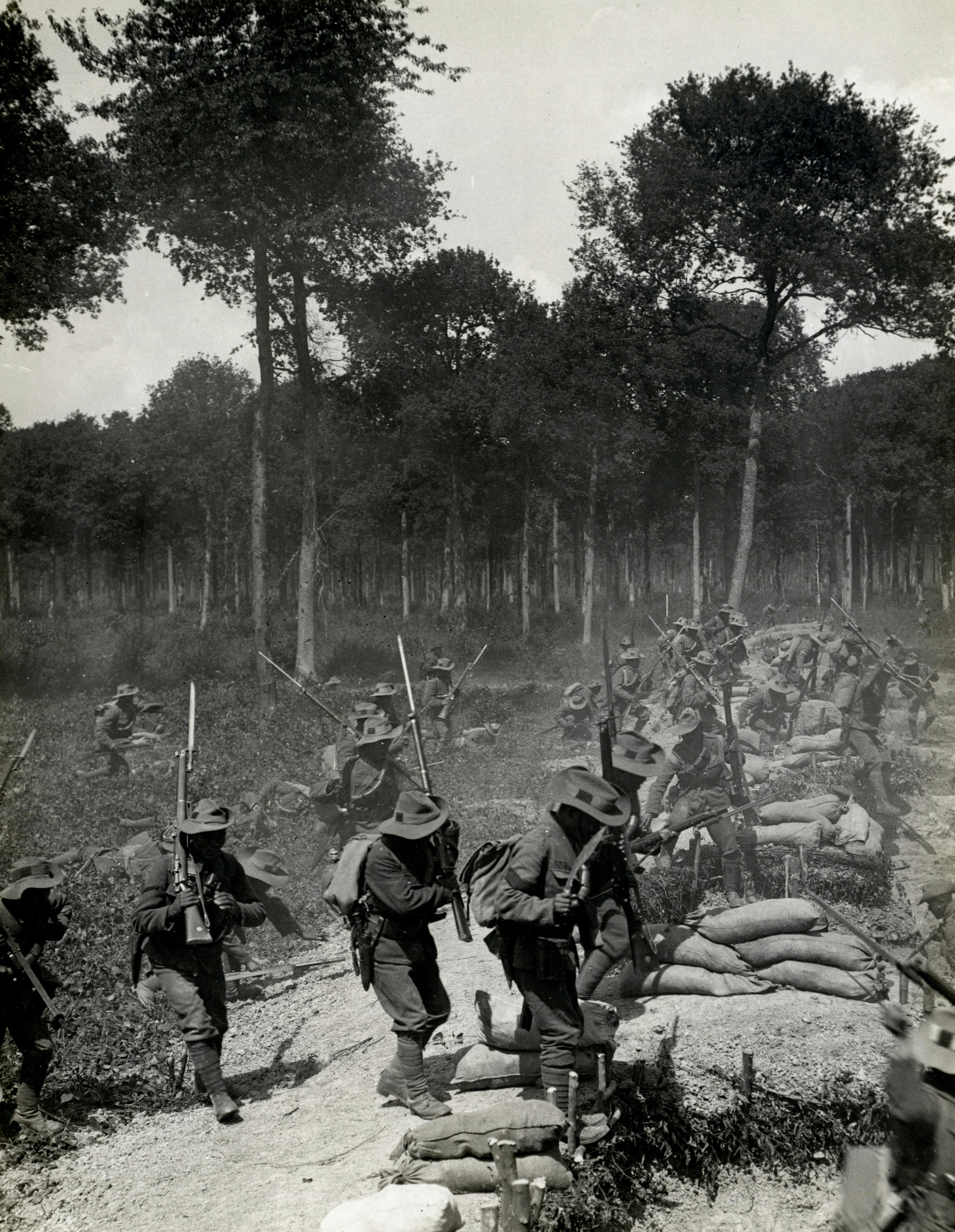 Archival black-and-white photo of soldiers advancing through wooded terrain during a military offensive, evoking themes of civil war, armed rebellion, and secessionist conflict relevant to the political unrest surrounding the Duterte impeachment crisis in the Philippines.